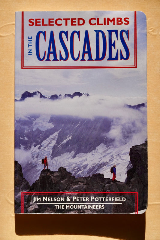 Book cover of 'Selected Climbs in the Cascades' with mountain scene and climbers on a beige background